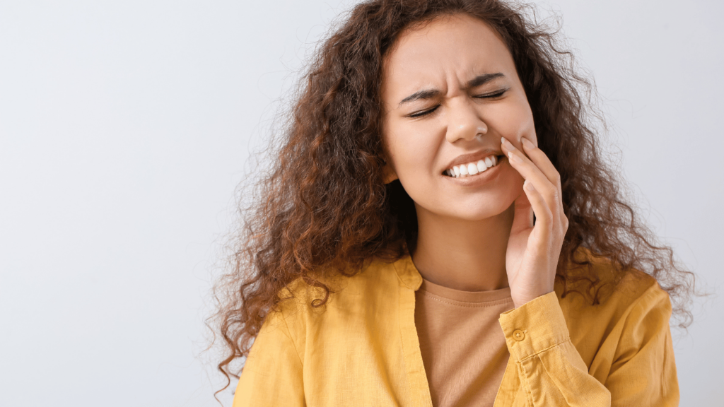 Woman experiencing tooth pain possibly related to Suboxone use, highlighting dental side effects like enamel sensitivity and dry mouth during recovery