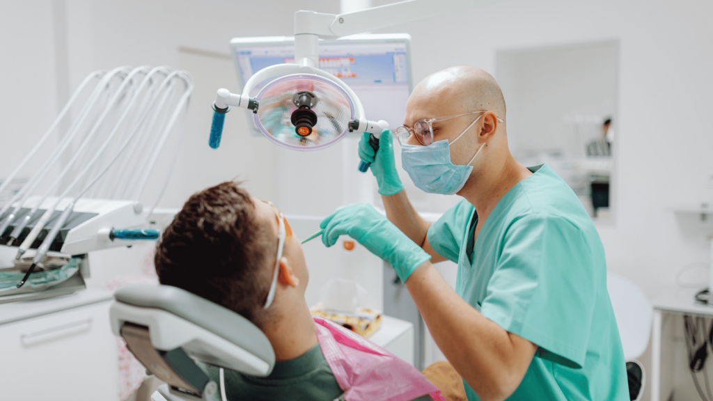 Dentist examining patient's teeth during a dental check-up, highlighting oral health care during Suboxone treatment