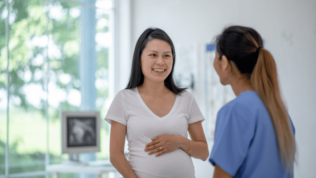 Pregnant woman speaking with a nurse about Suboxone treatment during pregnancy for opioid use disorder