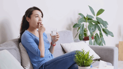Woman taking pain medication