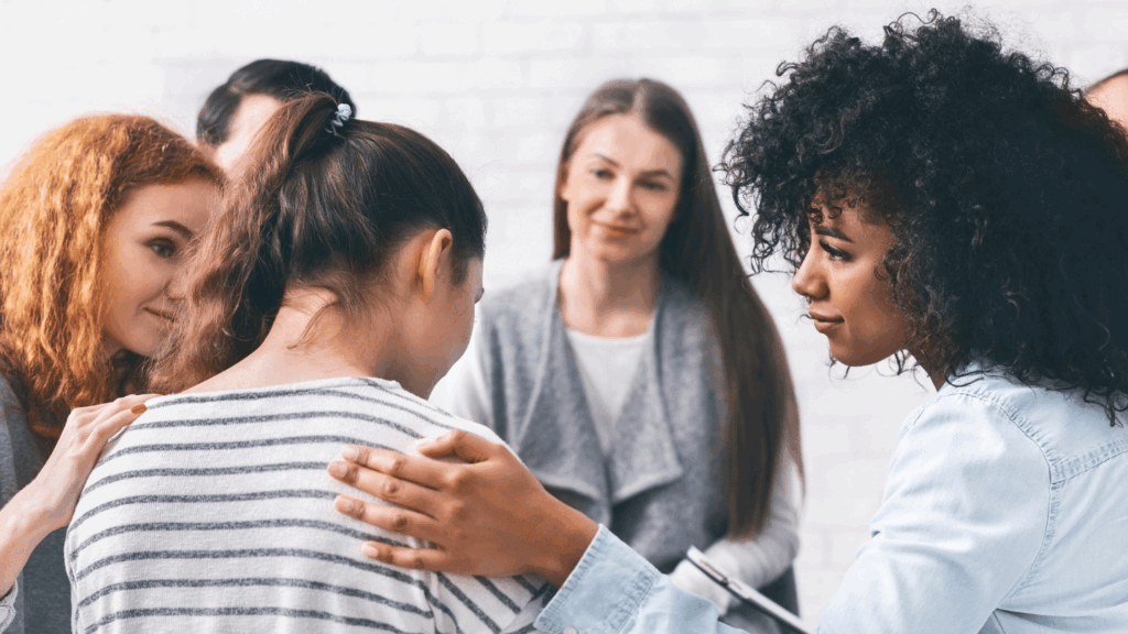 Support group comforting a young woman during addiction recovery, symbolizing empathy, healing, and the power of community in overcoming fentanyl addiction