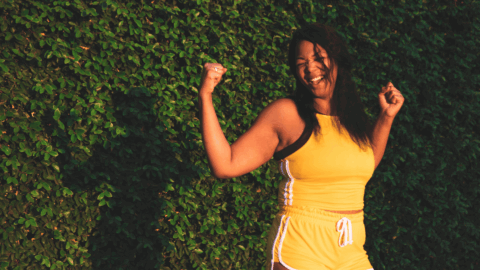 Woman celebrating weight loss success through GLP-1 medications, healthy eating, and exercise for sustainable wellness