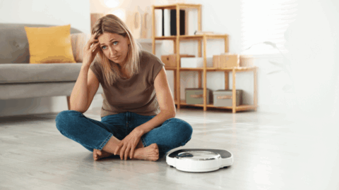 Sitting woman experiencing Ozempic rebound