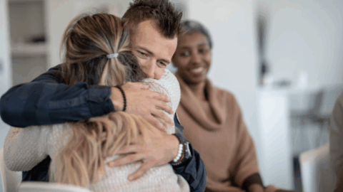 Man and woman embracing during fentanyl addiction recovery therapy session