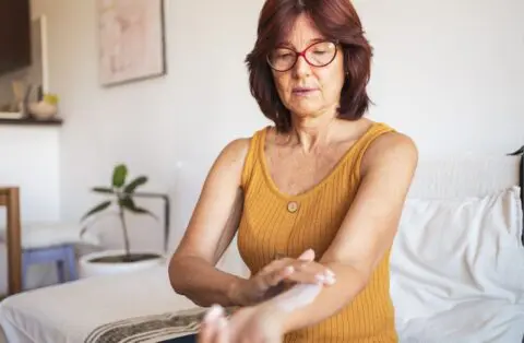 woman apply cream for hormone replacement therapy