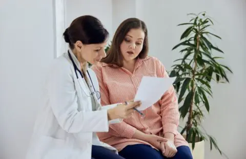 woman at doctor's office learning about early menopause
