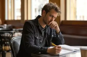 person reflecting and journaling about addiction