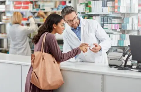 woman at pharmacy getting prescription