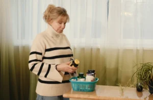 Woman reviewing bottles of estrogen supplements from a basket at home.