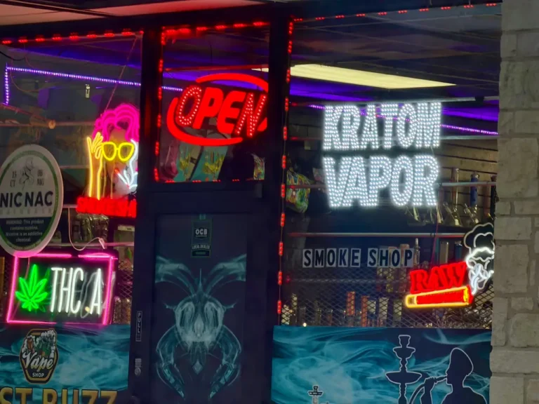 kratom-and-vape-smoke-shop-storefront-with-colorful-neon-signs-displaying-kratom-THC-and-vape-shop-displays