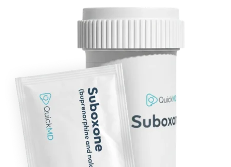 QuickMD Suboxone (buprenorphine and naloxone) medication bottle and film strip packet on white background