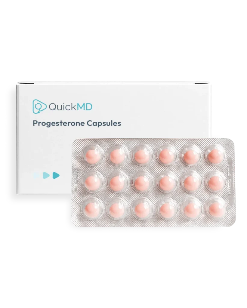 QuickMD Progesterone Capsules box with a blister pack of 15 pink oral capsules on white background