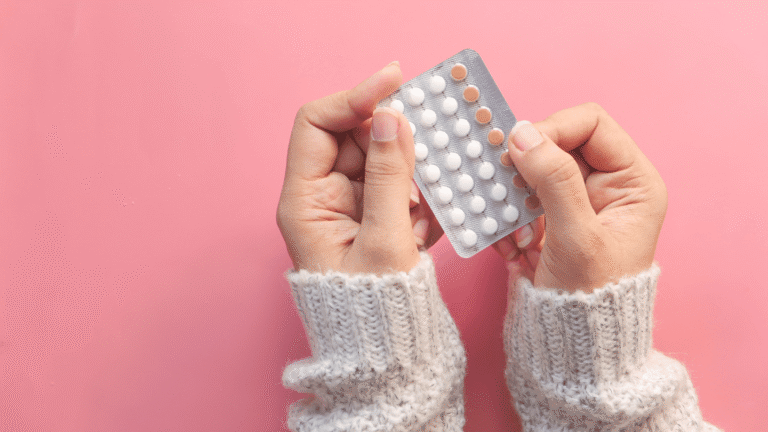Woman holding oral birth control pills