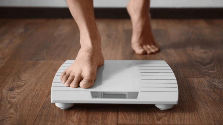 Close-up of a person stepping onto a digital scale