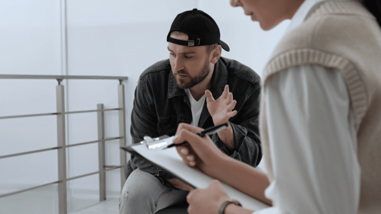 Man discussing opioid addiction treatment options with a healthcare provider during a consultation