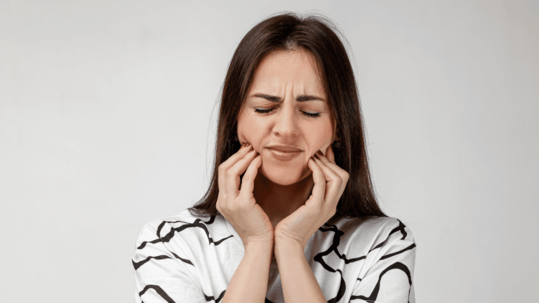 Woman with tooth pain holding her jaw