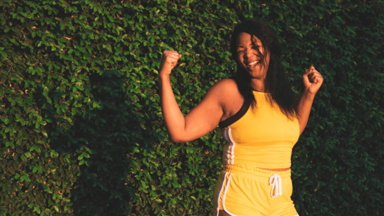 Woman celebrating weight loss success through GLP-1 medications, healthy eating, and exercise for sustainable wellness