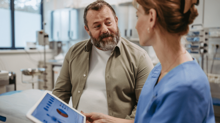 Man with obesity discussing weight-related breathing problems and GLP-1 treatment options with a healthcare provider in a clinic