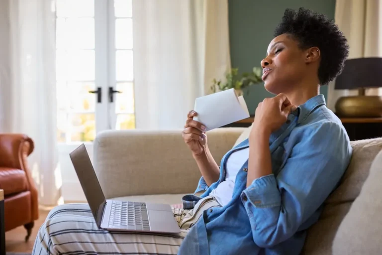 woman-experiencing-a-hot-flash-on-couch