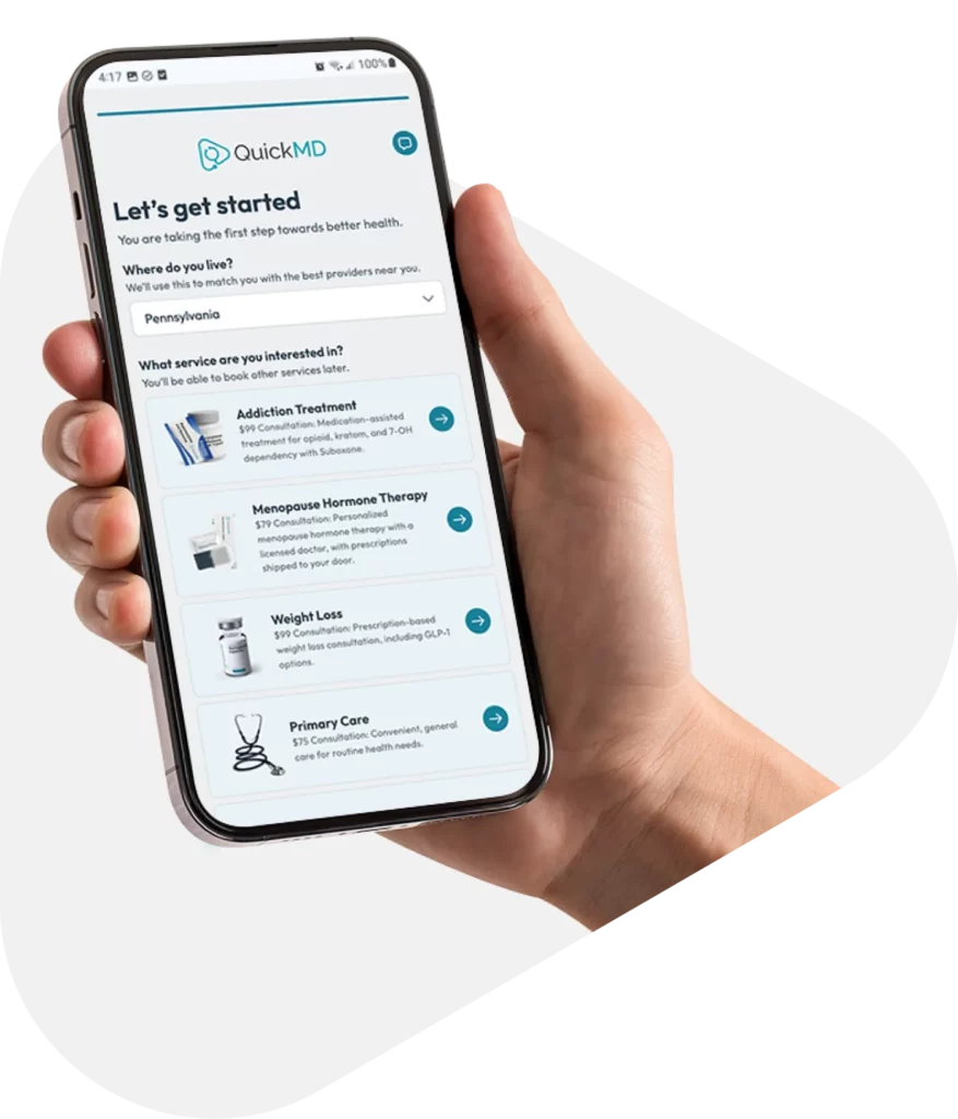 Hand holding a smartphone displaying the QuickMD app's "Let's get started" onboarding screen with telehealth service options.