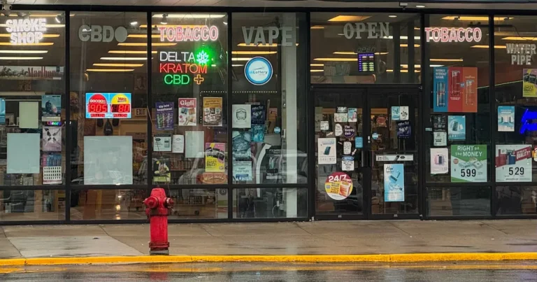 smoke-shop-storefront-with-neon-signs-advertising-kratom-CBD-vape-and-tobacco-products