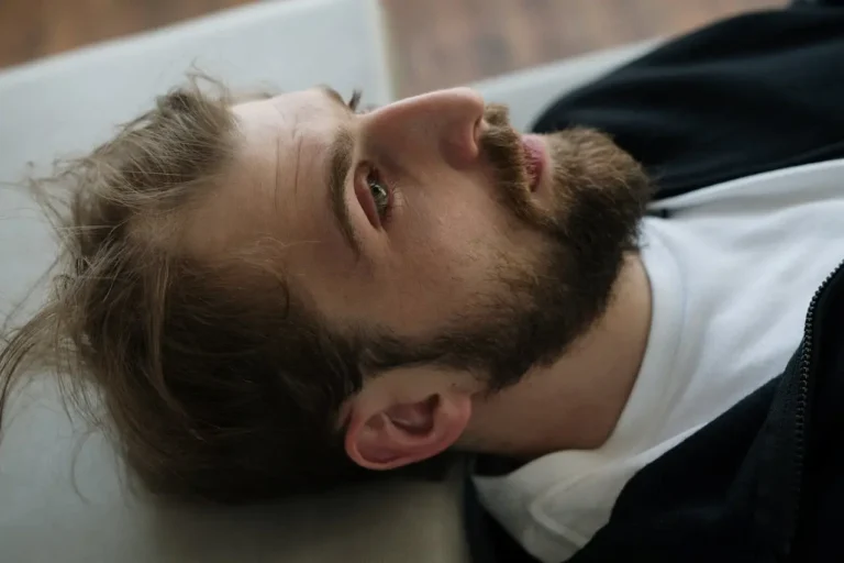 man-staring-at-cieling-thinking-potentially-in-pain
