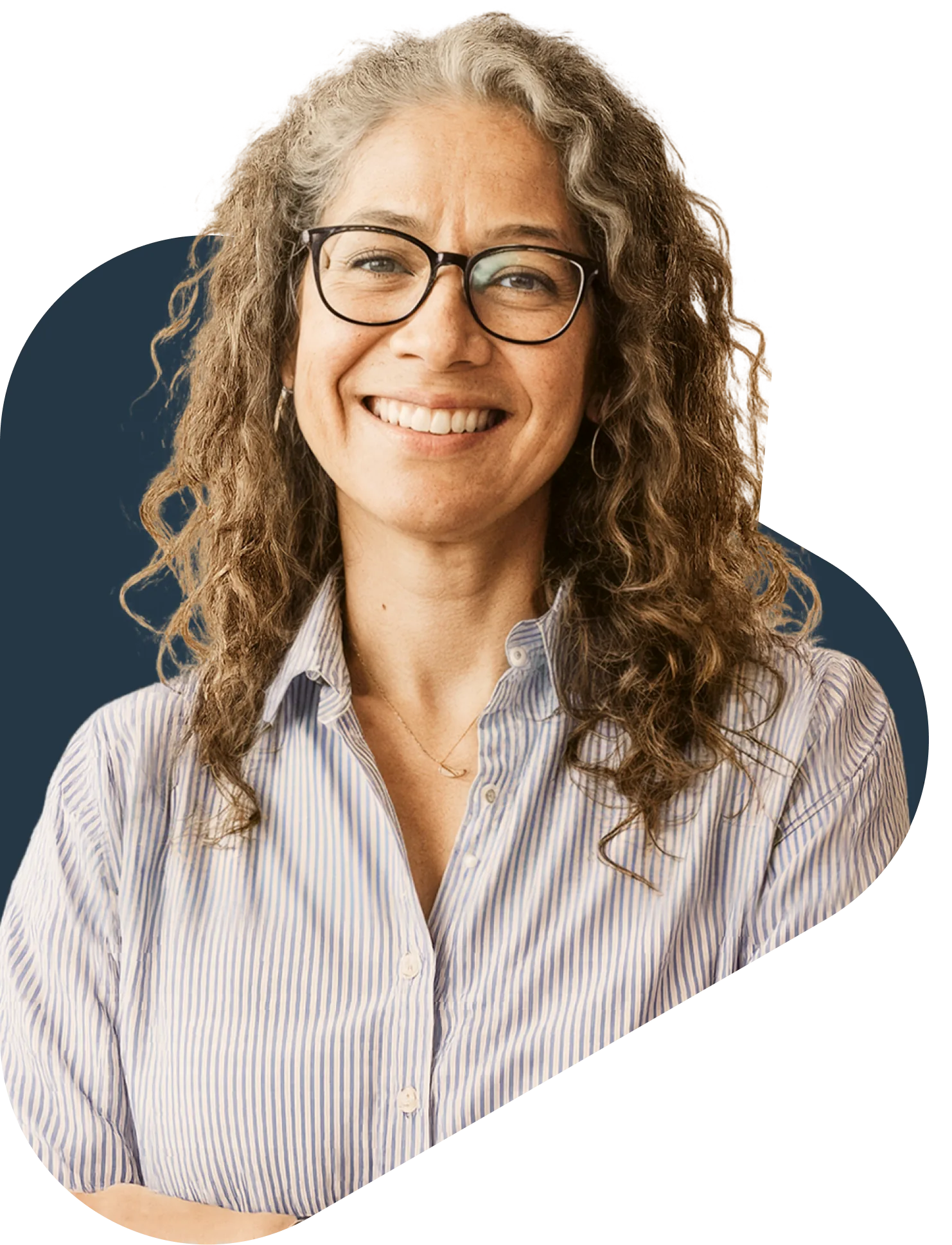 Smiling middle-aged woman with curly hair and glasses wearing a striped shirt, representing urgent care telehealth services