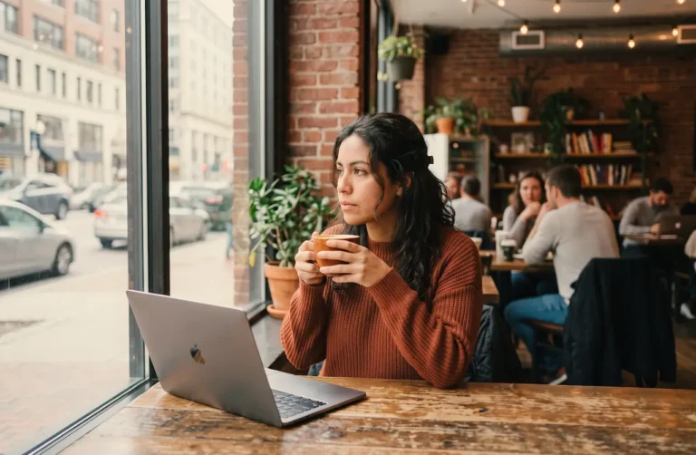 woman-at-coffee-shop-staring-out-the-window-contemplating-anxiety-and-depression