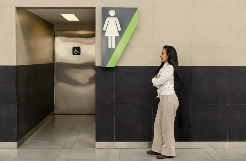 woman-standing-waiting-to-use-the-bathroom