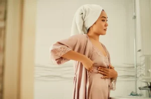 woman-examing-breast-for-cancer