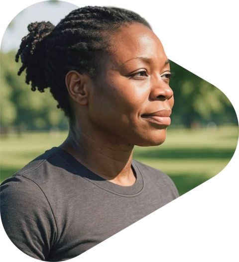 athletic middle aged woman standing in a grass field