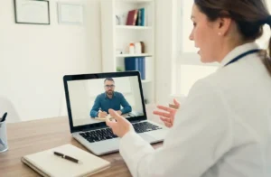 doctor speaking to patient virtually