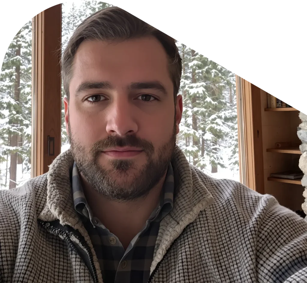 Man in sweater in his room with a snowy background on a QuickMD telehealth call