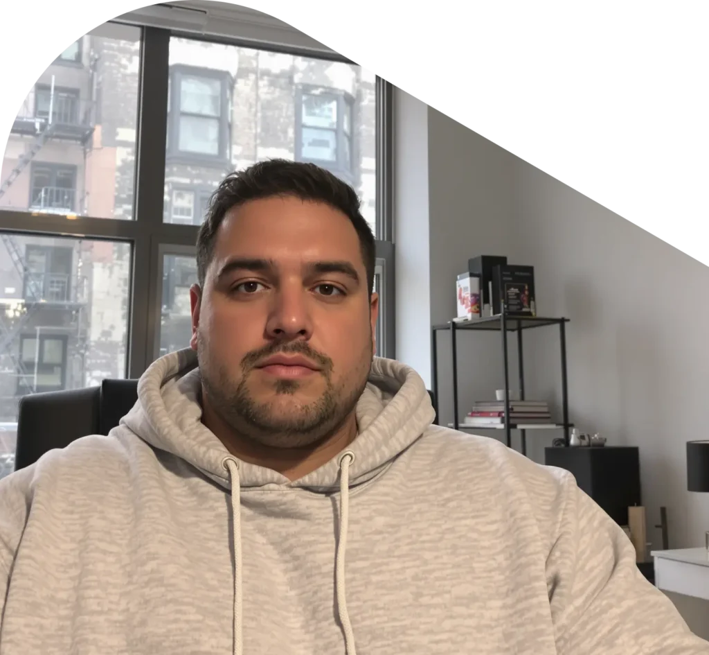 Man in gray sweatshirt in the city on a QuickMD telehealth call