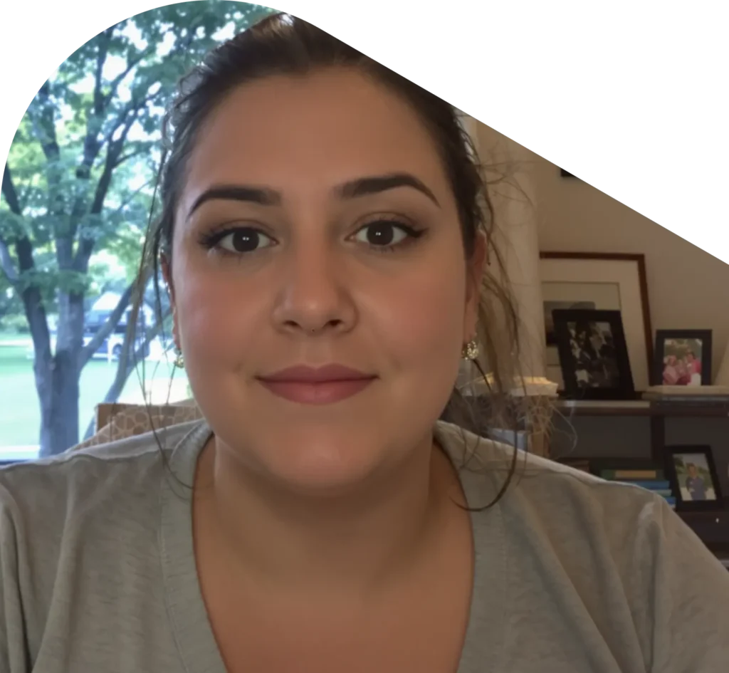 Woman sitting in room with tree in background on a QuickMD telehealth call