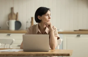woman-at-computer-in-kitchen-thinking