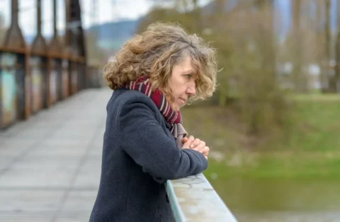 woman-staring-out-over-a-bridge