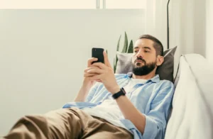 man-sitting-on-couch-doom-scrolling