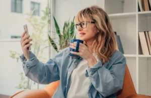 woman-on-phone-with-doctor-holding-coffee-in-hand
